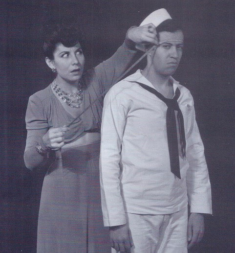 woman and man in black and white, woman is measuring distance from sailor's head to something On The Town lecture about sailors in New York by Richard Hanson