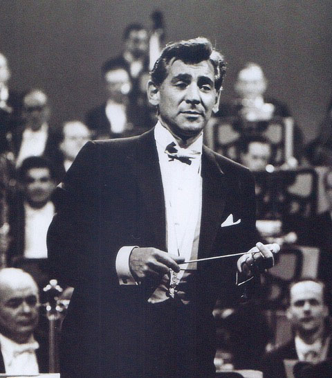 black and white photo of man in tuxedo in front of orchestra as conductor Leonard Bernstein part of Richard Hanson lecture